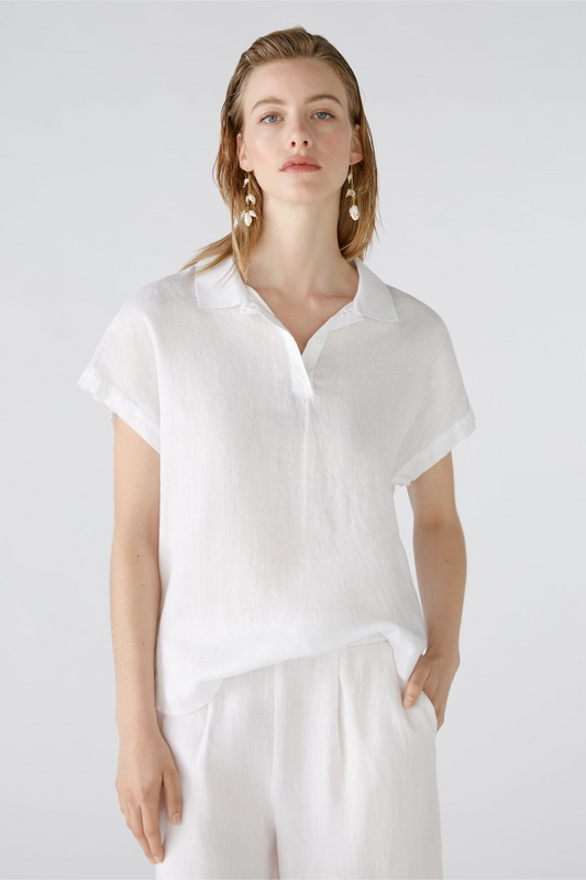 POLO-STYLE BLOUSE IN LINEN-COTTON JERSEY PATCH Pure linen at the front with tonal jersey patch at the back for added comfort Sporty polo style in regular fit Typical polo collar, short, narrow button placket Slightly dropped shoulder, falls relaxed over the arm Modern H-shape with slightly overcut shoulder