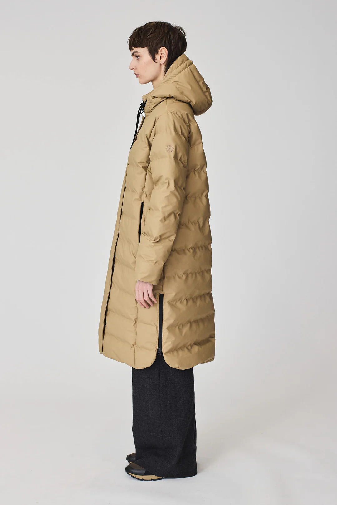 Person wearing a beige puffer coat