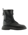 A single black leather ankle boot with a thick platform sole, side zipper, and pull tab, shown from a side profile on a white background.  Ernesto Dolani
