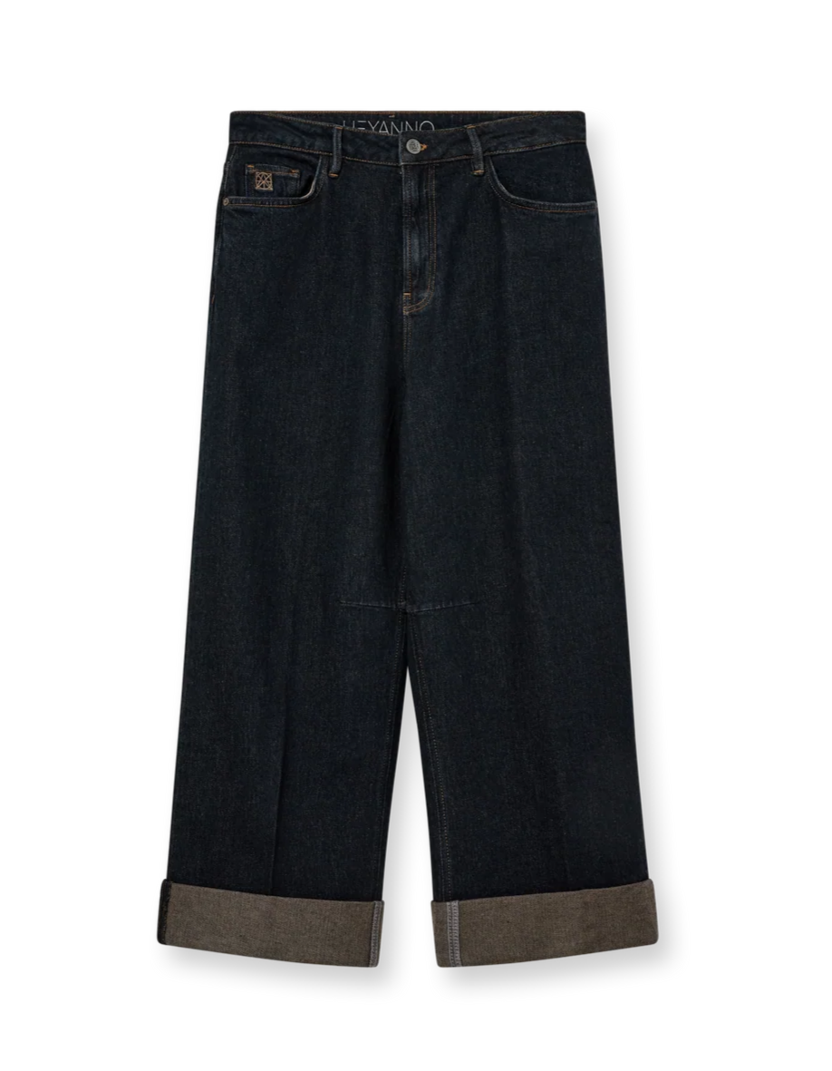 Dark wide-leg jeans with brown trim on a white background