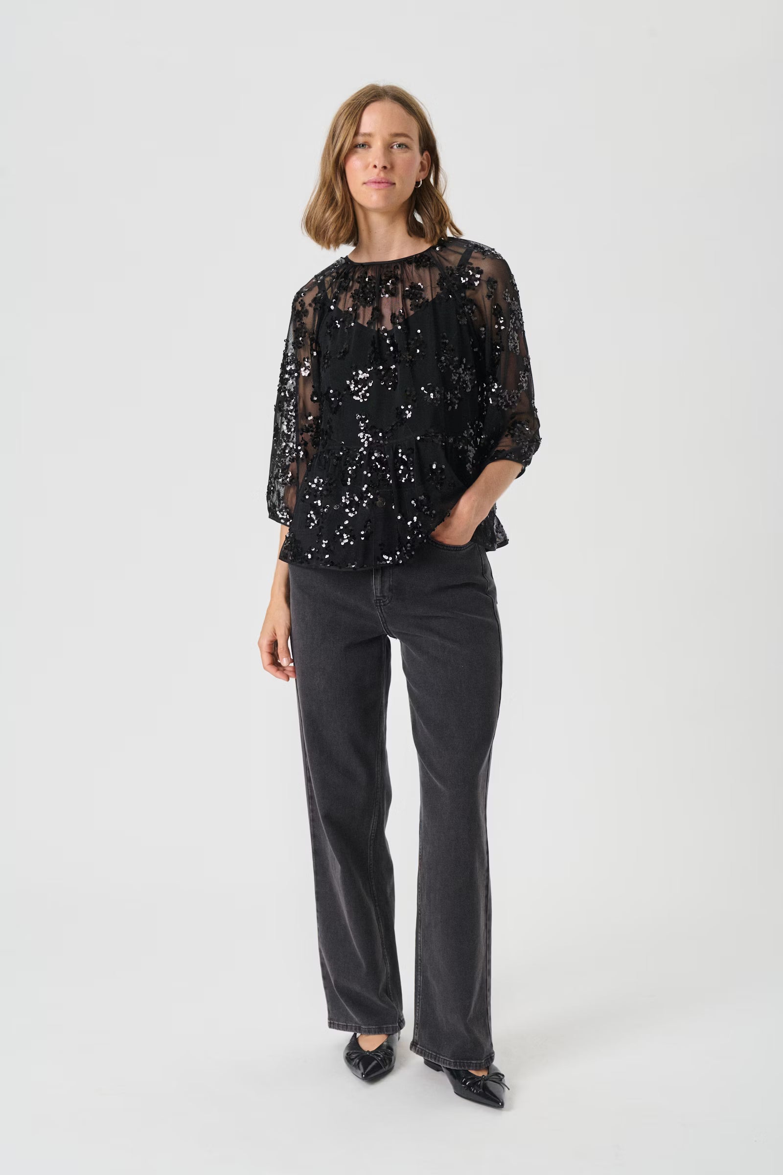 Woman wearing a black sequin blouse 