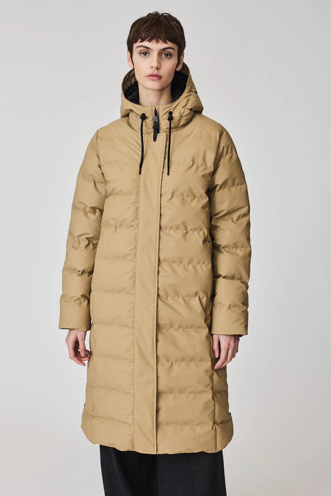 Person wearing a beige puffer coat 